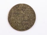 a close up of a coin on a white surface