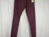 a pair of burgundy colored pants hanging on a white curtain