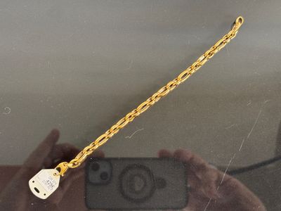 a person taking a picture of a chain with a cell phone