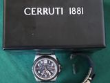 a close up of a watch in a box on a green surface
