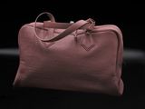 a pink leather handbag on a black background
