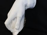 a close up of a white glove on a black background