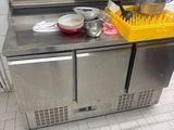 a stainless steel kitchen with a sink and a dishwasher on the counter
