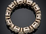 a close up of a diamond bracelet on a black surface