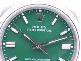 a watch with a green dial on a white background