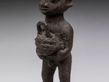 a statue of a man holding a baby in his arms