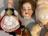 a doll laying on the floor next to other dolls