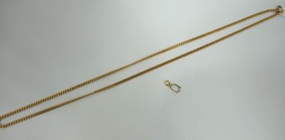 a close up of a gold necklace and a pair of earrings
