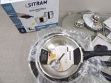 a silver pan with a spatula in it sitting on a table