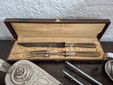 a knife, fork, and spoon in a case on a table