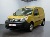 La camionnette jaune est garée dans une pièce blanche au sol noir.