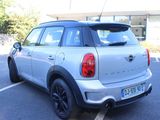 a silver mini cooper parked in a parking lot
