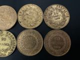 six different types of coins sitting on a black surface