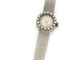 a close up of a wrist watch on a white surface