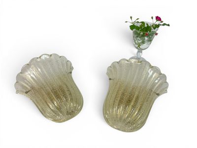 two vases that have flowers in them on the wall