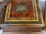 a wooden box sitting next to a book on a table
