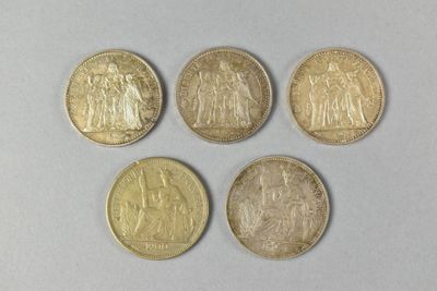 four different types of gold coins on a white surface