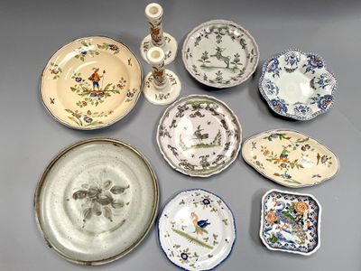 a lot of plates and vases on the table