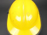 a yellow hard hat that is sitting on a table