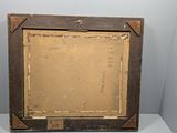 an old picture frame sitting on top of a white table