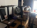 a room with a lot of furniture and a fan in it