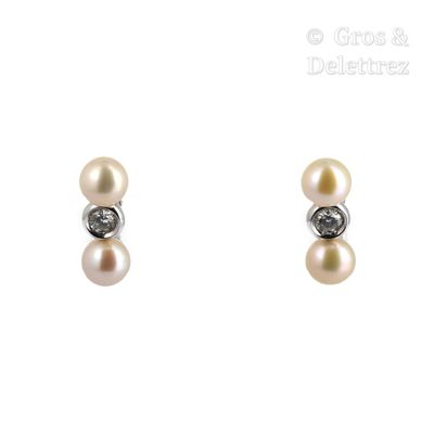 pair of pearl and diamond earrings on a white background