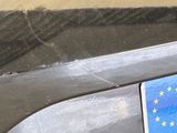 a passport sitting on top of a car with a european flag on it