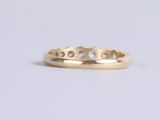 an image of a gold ring with three diamonds on it