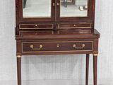 a small desk with a mirror on top of it