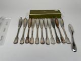 a lot of silverware sitting on a table next to a green box