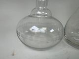 two empty glass vases sitting on a table