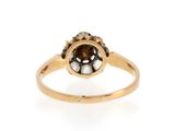 a close up of a gold ring with a brown and white diamond