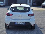 a white car parked in front of a building