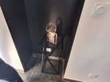 a person standing next to a small chair in a room