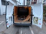 a white van with its doors open in a parking lot