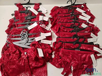 de nombreuses paires de ciseaux sur un soutien-gorge en dentelle rouge