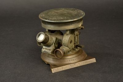 a small brass object with a clock on it