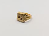 a close up of a gold ring with the letter r on it