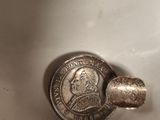 a coin sitting on top of a sink in a bathroom