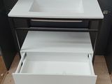 a white sink and a black cabinet in a room