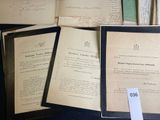 many old papers on a table with a price tag