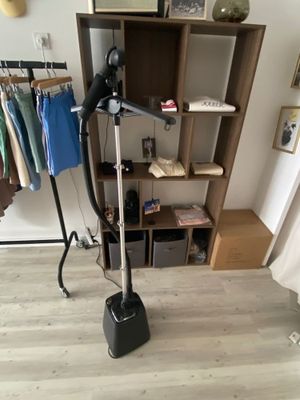 an image of a room with a clothes rack and a hair dryer