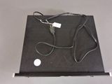 a laptop with a cable connected to it on a table