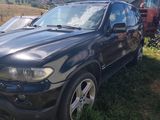 a picture of a black suv parked in a field
