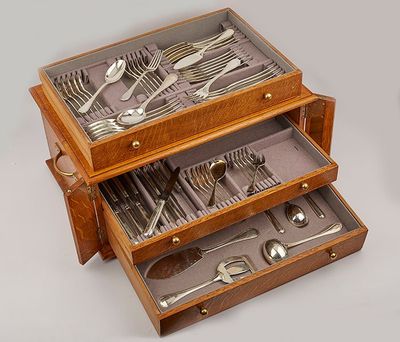 a wooden box with silverware in it on a table