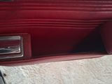 a red purse that is sitting on the floor