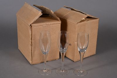 two empty wine glasses in front of a cardboard box