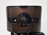 a coffee maker with a digital clock on it