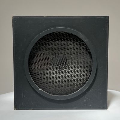 a black speaker sitting on top of a white table