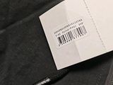 a label on the back of a jacket with a barcode on it